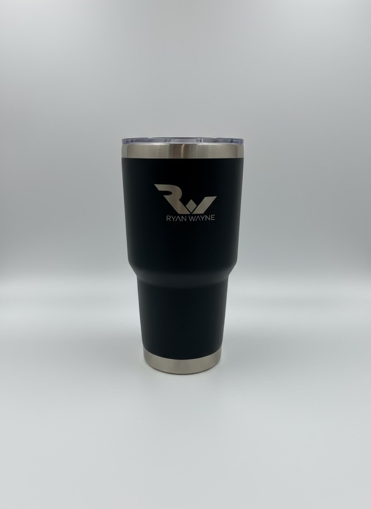 Black tumbler with silver rim and 'Ryan Wayne' logo on a white surface.