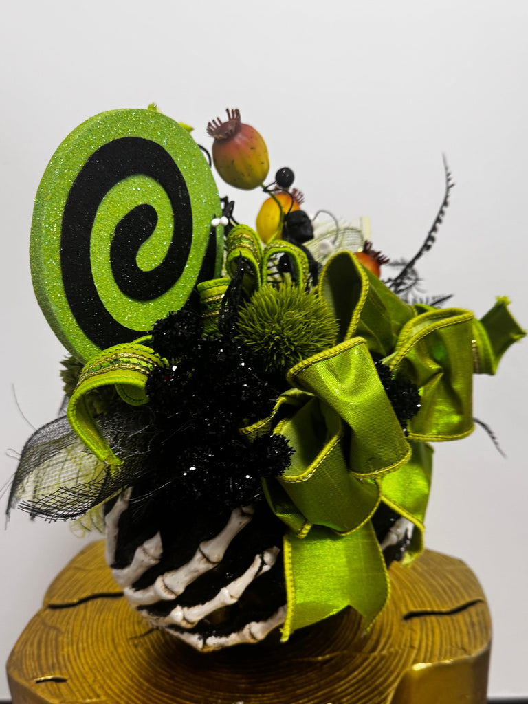 Decorative wreath with green and black elements on a white background