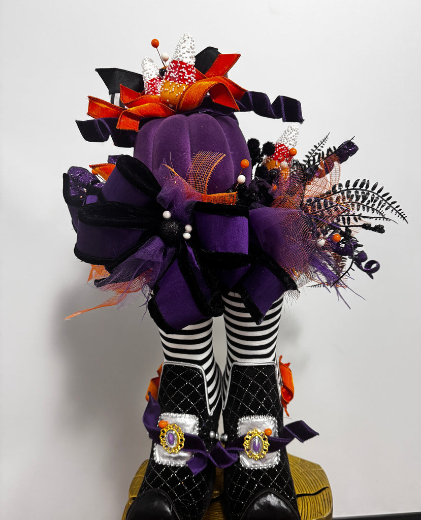 Decorative headbands with purple flowers and black and white striped ribbons on a white background