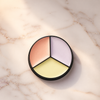 Ryan Wayne three-tone color-correcting concealer compact on white marble