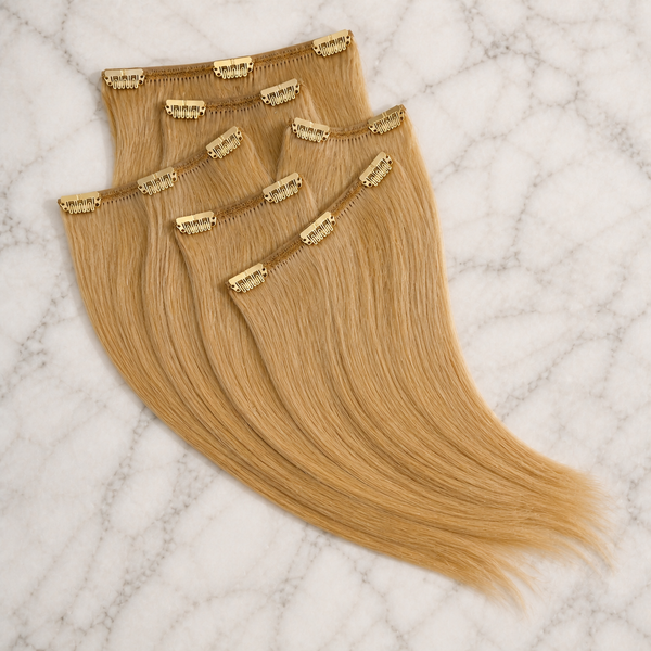 Ryan Wayne blonde CLIP 18 human-hair extensions arranged on white marble