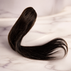 Ryan Wayne dark brown human hair claw clip on white marble